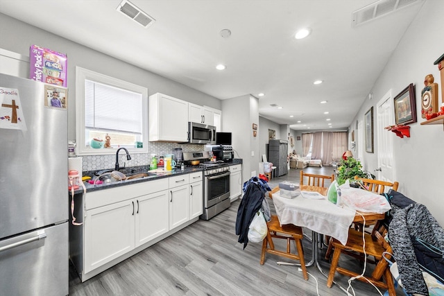 8543 S Burley Ave, Chicago, IL 60617 - kitchen featuring stainless steel appliances, a sink, backsplash, light wood finished floors, and recessed lighting