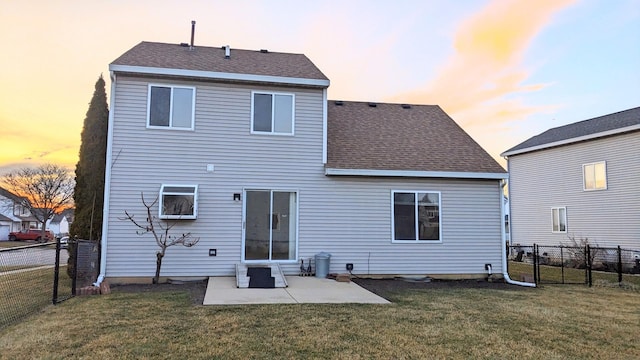 653 Fairview Ln, South Elgin, IL 60177 - back of house at dusk featuring a patio area and a shingled roof