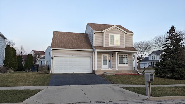 653 Fairview Ln, South Elgin, IL 60177 - traditional home with asphalt driveway, a garage, a front lawn, and covered porch