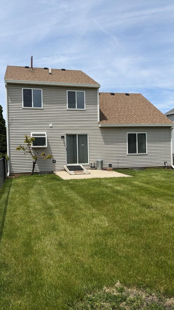653 Fairview Ln, South Elgin, IL 60177 - rear view of property featuring a patio area and roof with shingles
