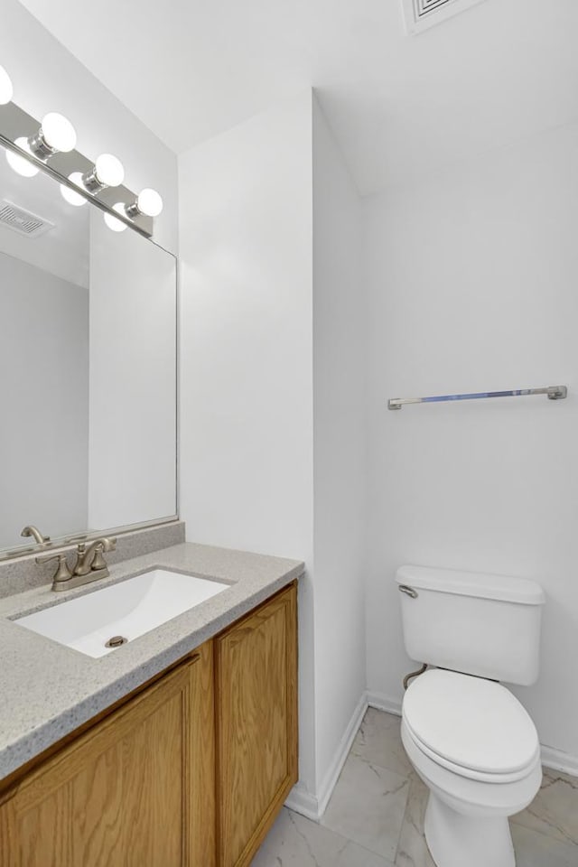 653 Fairview Ln, South Elgin, IL 60177 - bathroom with vanity, marble look tiles, toilet, and baseboards