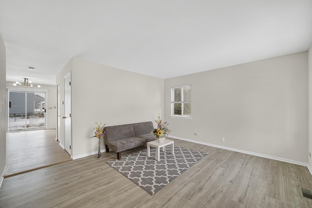 653 Fairview Ln, South Elgin, IL 60177 - sitting room featuring a chandelier, wood finished floors, and baseboards