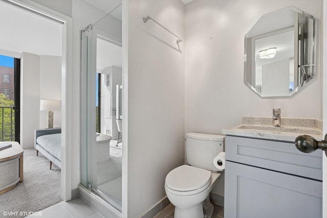345 W Fullerton Pkwy Unit 601, Chicago, IL 60614 - ensuite bathroom featuring vanity, a shower stall, toilet, tile patterned flooring, and baseboards