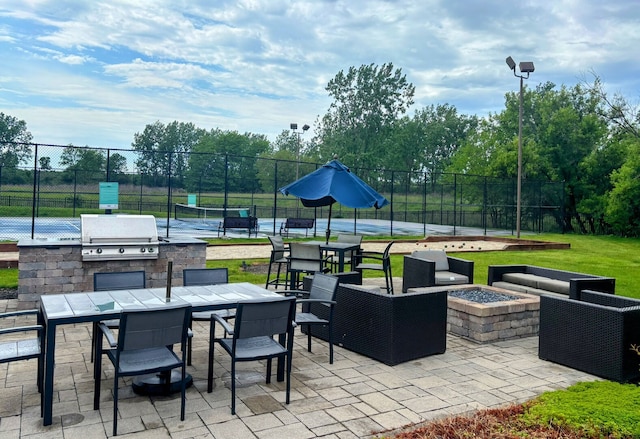 2000 Chestnut Ave Unit 507, Glenview, IL 60025 - view of patio / terrace featuring a fire pit, outdoor dining space, and a tennis court