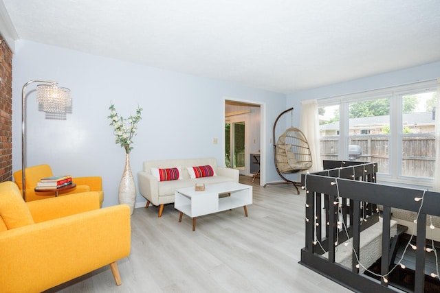 203 S Hershey Rd, Bloomington, IL 61704 - living area with light wood finished floors, brick wall, and baseboards