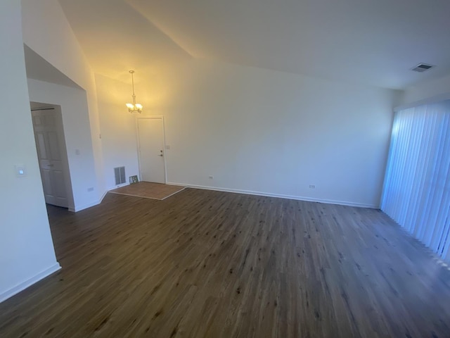 1518 Harbour Ct Unit 2A, Schaumburg, IL 60193 - unfurnished living room featuring dark wood-type flooring, a chandelier, baseboards, and vaulted ceiling