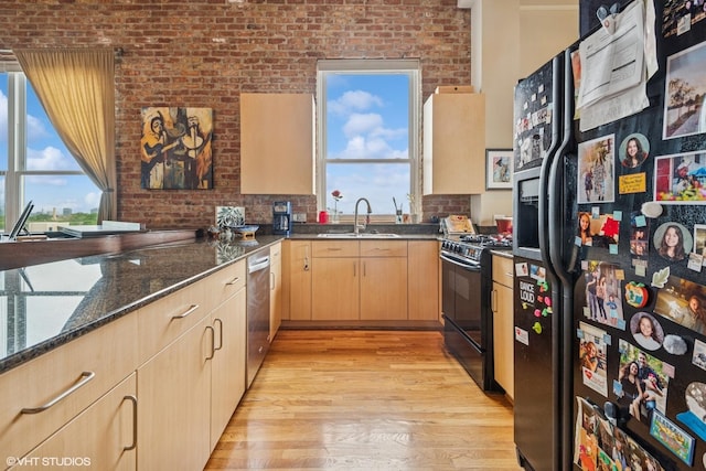 1625 N Western Unit 502, Chicago, IL 60647 - kitchen featuring black appliances, light brown cabinetry, a sink, light wood-type flooring, and healthy amount of natural light