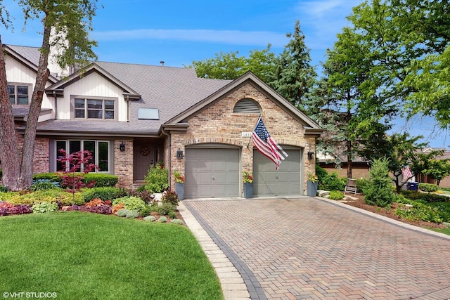 14352 Crystal Tree Dr, Orland Park, IL 60462 - view of front of home featuring decorative driveway, a garage, brick siding, a front yard, and roof with shingles