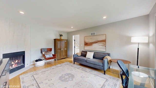 14352 Crystal Tree Dr, Orland Park, IL 60462 - living area with wood finished floors, a tile fireplace, recessed lighting, stairway, and baseboards