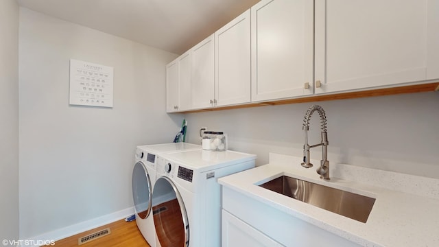 14352 Crystal Tree Dr, Orland Park, IL 60462 - washroom with washer and clothes dryer, cabinet space, baseboards, and light wood-style flooring