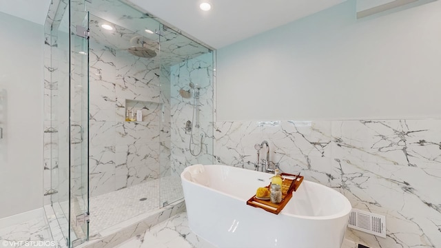 14352 Crystal Tree Dr, Orland Park, IL 60462 - full bathroom featuring a freestanding bath, a marble finish shower, recessed lighting, marble tiled flooring, and tile walls