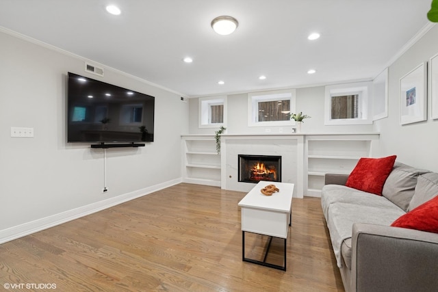4428 N Racine Ave Unit Gn, Chicago, IL 60640 - living room featuring ornamental molding, light wood-style flooring, a premium fireplace, recessed lighting, and baseboards