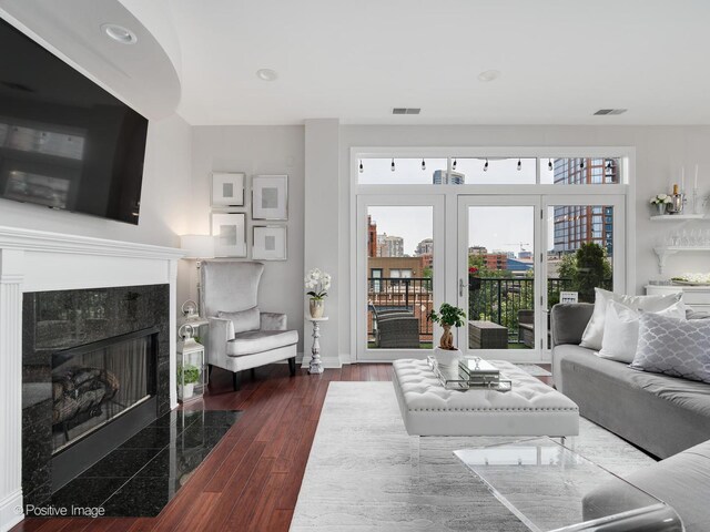 550 W Fulton St Unit 404, Chicago, IL 60661 - living area featuring a fireplace, baseboards, wood finished floors, and recessed lighting