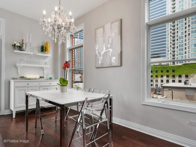 550 W Fulton St Unit 404, Chicago, IL 60661 - dining area with dark wood-style floors, baseboards, and a chandelier