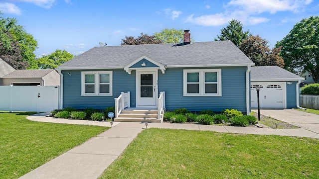 325 Goodrich St, Belvidere, IL 61008 - view of front facade with a chimney, a garage, roof with shingles, driveway, and a gate