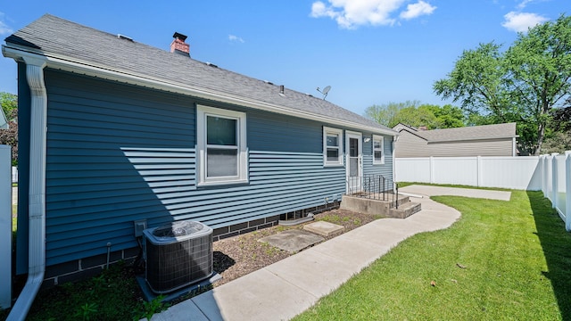 325 Goodrich St, Belvidere, IL 61008 - rear view of property with central AC, a chimney, and a shingled roof