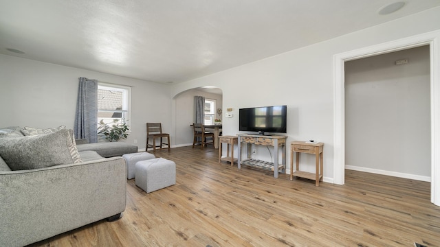 325 Goodrich St, Belvidere, IL 61008 - living area with arched walkways, light wood-type flooring, and baseboards