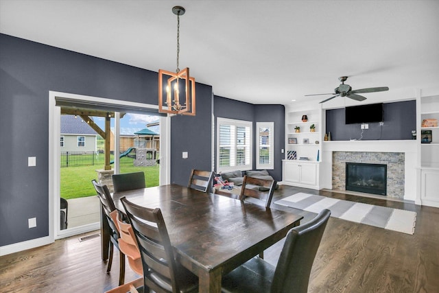 1407 Winterberry Rd, Savoy, IL 61874 - dining area with wood finished floors, a fireplace, a ceiling fan, and built in shelves