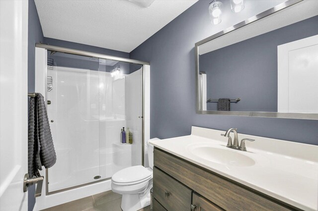 1407 Winterberry Rd, Savoy, IL 61874 - bathroom with a stall shower, tile patterned flooring, vanity, and a textured ceiling