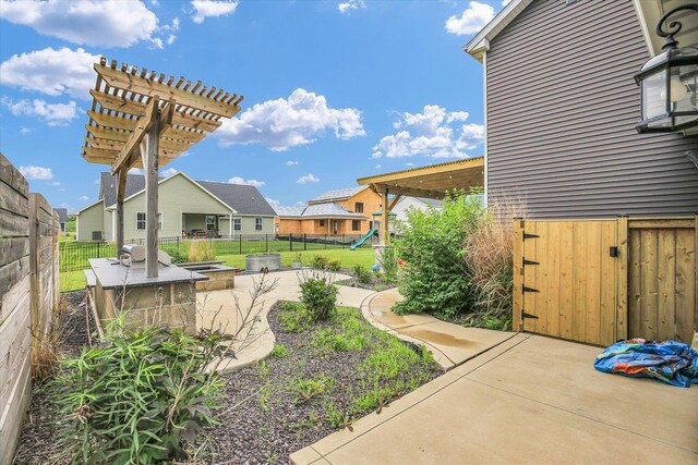 1407 Winterberry Rd, Savoy, IL 61874 - fenced backyard featuring a patio area, a playground, and a residential view