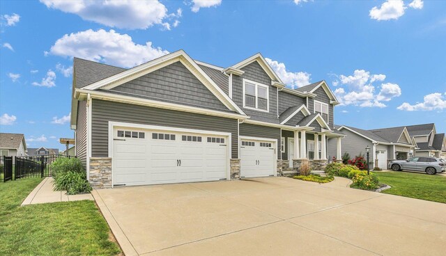 1407 Winterberry Rd, Savoy, IL 61874 - craftsman inspired home with stone siding, driveway, and an attached garage