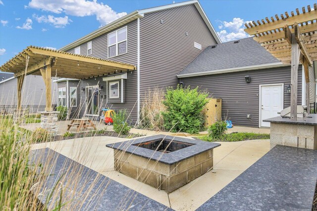 1407 Winterberry Rd, Savoy, IL 61874 - back of house with a fire pit, a patio area, a pergola, and a shingled roof