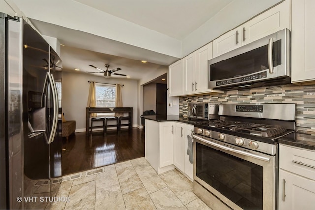 221 Cornwall Dr, Crete, IL 60417 - kitchen featuring appliances with stainless steel finishes, backsplash, white cabinetry, and recessed lighting