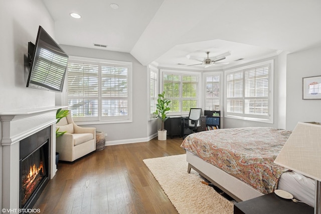 3414 N Bell Ave, Chicago, IL 60618 - bedroom with a lit fireplace, wood finished floors, baseboards, recessed lighting, and a desk