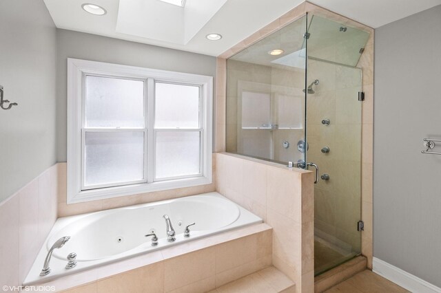 3414 N Bell Ave, Chicago, IL 60618 - bathroom featuring a jetted tub, a shower stall, a skylight, and recessed lighting