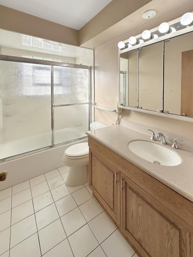 5431 S 7th Ave, Countryside, IL 60525 - bathroom featuring vanity, toilet, shower / bath combination with glass door, and tile patterned flooring