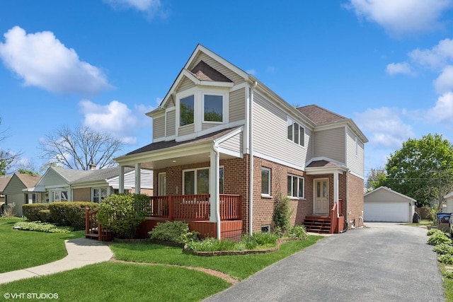 877 Hollywood Ave, Des Plaines, IL 60016 - view of front facade with brick siding, a detached garage, an outbuilding, and a front yard