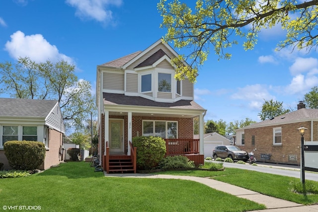 877 Hollywood Ave, Des Plaines, IL 60016 - view of front of home with a porch, a front yard, brick siding, and a shingled roof