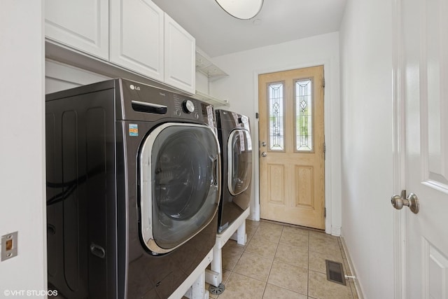 877 Hollywood Ave, Des Plaines, IL 60016 - laundry room with washer and clothes dryer, cabinet space, light tile patterned flooring, and baseboards