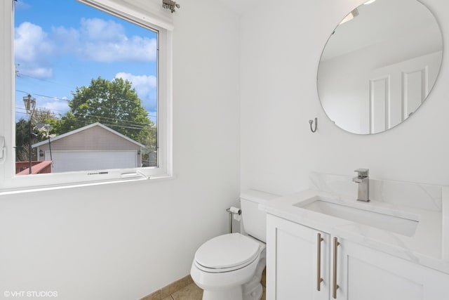 877 Hollywood Ave, Des Plaines, IL 60016 - half bath with vanity, toilet, healthy amount of natural light, and tile patterned flooring