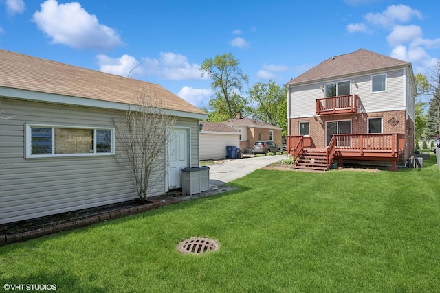 877 Hollywood Ave, Des Plaines, IL 60016 - back of house featuring a balcony, a lawn, a deck, and brick siding