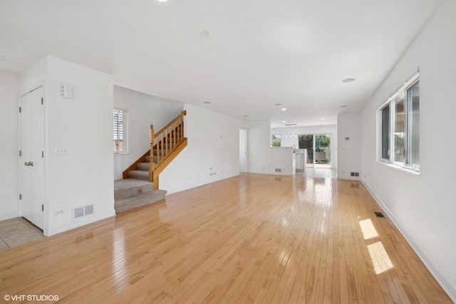 877 Hollywood Ave, Des Plaines, IL 60016 - unfurnished living room featuring light wood finished floors, stairs, recessed lighting, and baseboards