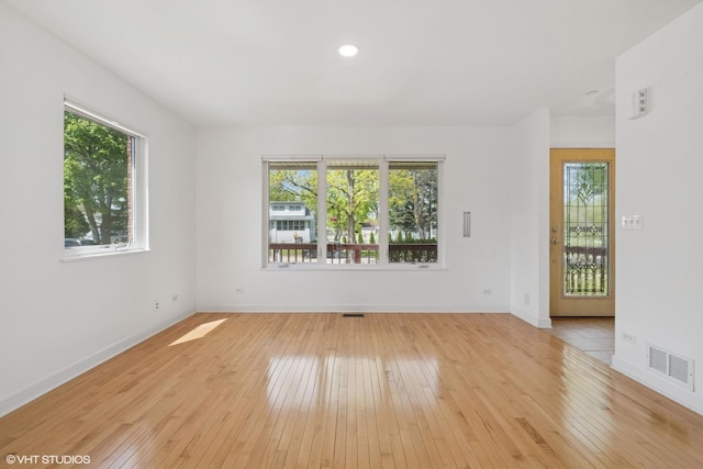 877 Hollywood Ave, Des Plaines, IL 60016 - empty room featuring light wood finished floors, healthy amount of natural light, baseboards, and recessed lighting