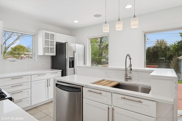 877 Hollywood Ave, Des Plaines, IL 60016 - kitchen featuring stainless steel appliances, a sink, light countertops, glass insert cabinets, and white cabinets