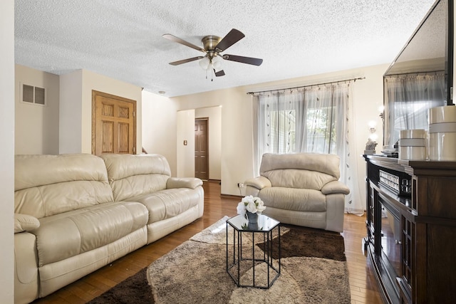 16203 Fox Ct, Orland Hills, IL 60487 - living room featuring a ceiling fan, wood finished floors, and a textured ceiling