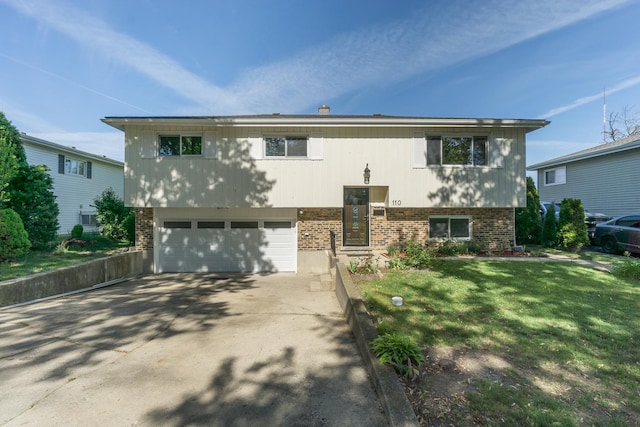 110 S Evergreen Ave, Addison, IL 60101 - split foyer home with brick siding, driveway, a garage, and a front lawn