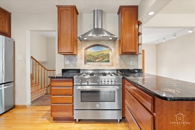 9258 Clancy Dr, Des Plaines, IL 60016 - kitchen with wall chimney exhaust hood, stainless steel appliances, a peninsula, and backsplash