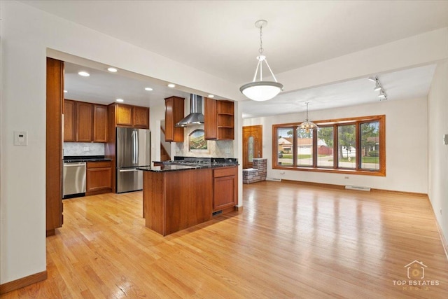 9258 Clancy Dr, Des Plaines, IL 60016 - kitchen featuring stainless steel appliances, wall chimney range hood, brown cabinetry, backsplash, and light wood-style flooring