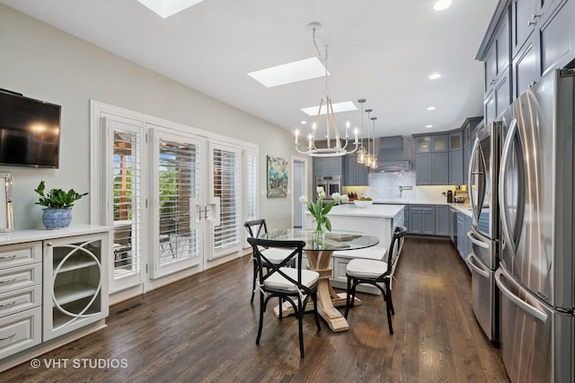 3118 Oliver Ln, Northbrook, IL 60062 - dining area with a skylight, a chandelier, dark wood-style floors, and recessed lighting