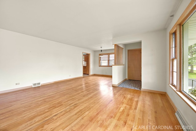 782 S Bryan St, Elmhurst, IL 60126 - spare room featuring light wood finished floors, baseboard heating, healthy amount of natural light, and baseboards
