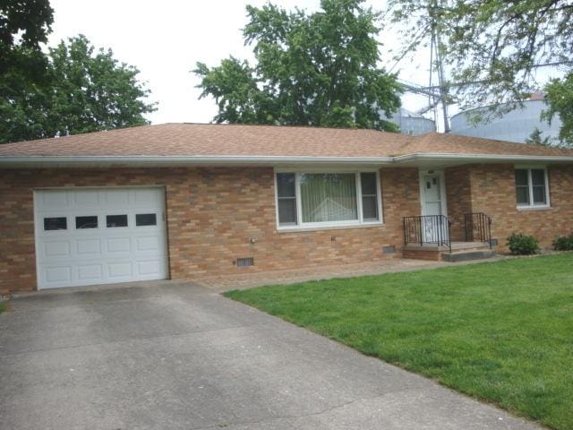 423 W Garfield Ave, Cissna Park, IL 60924 - ranch-style home with a garage, brick siding, a front lawn, driveway, and crawl space