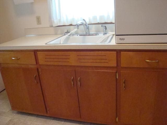 423 W Garfield Ave, Cissna Park, IL 60924 - kitchen with a sink, brown cabinets, and light countertops