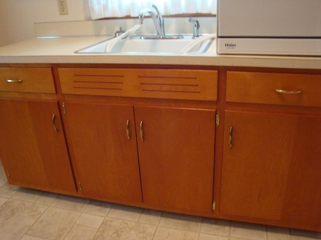 423 W Garfield Ave, Cissna Park, IL 60924 - kitchen featuring a sink, light countertops, and brown cabinetry