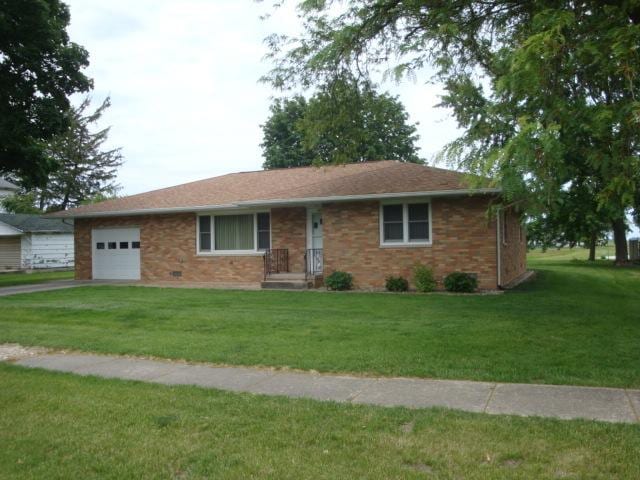 423 W Garfield Ave, Cissna Park, IL 60924 - ranch-style house with an attached garage, a front lawn, driveway, and brick siding
