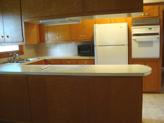 423 W Garfield Ave, Cissna Park, IL 60924 - kitchen with white appliances, a sink, light countertops, tasteful backsplash, and brown cabinets