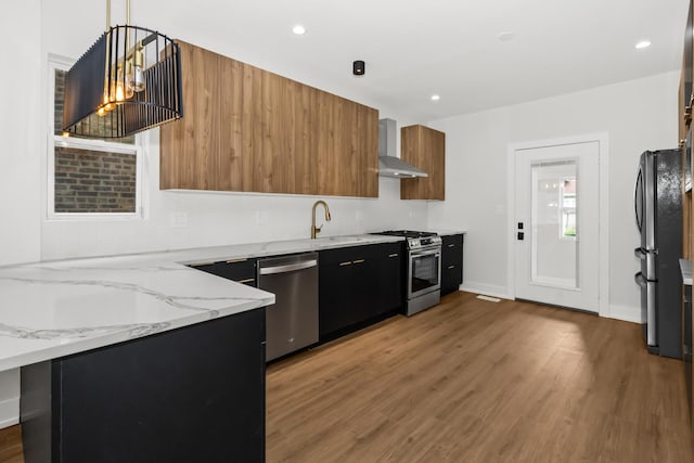 8114 S Paxton Ave, Chicago, IL 60617 - kitchen featuring stainless steel appliances, modern cabinets, wall chimney range hood, light wood-type flooring, and light stone countertops